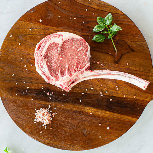 Prime Tomahawk Ribeye on cutting board Made in USA